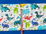 Cotton 100% Kids - turquoise-yellow dinosaurs with pterodactyl on a white back